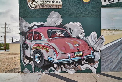 #ad An old hot rod car in action is depicted in this sign promoting the Dunton $9.99