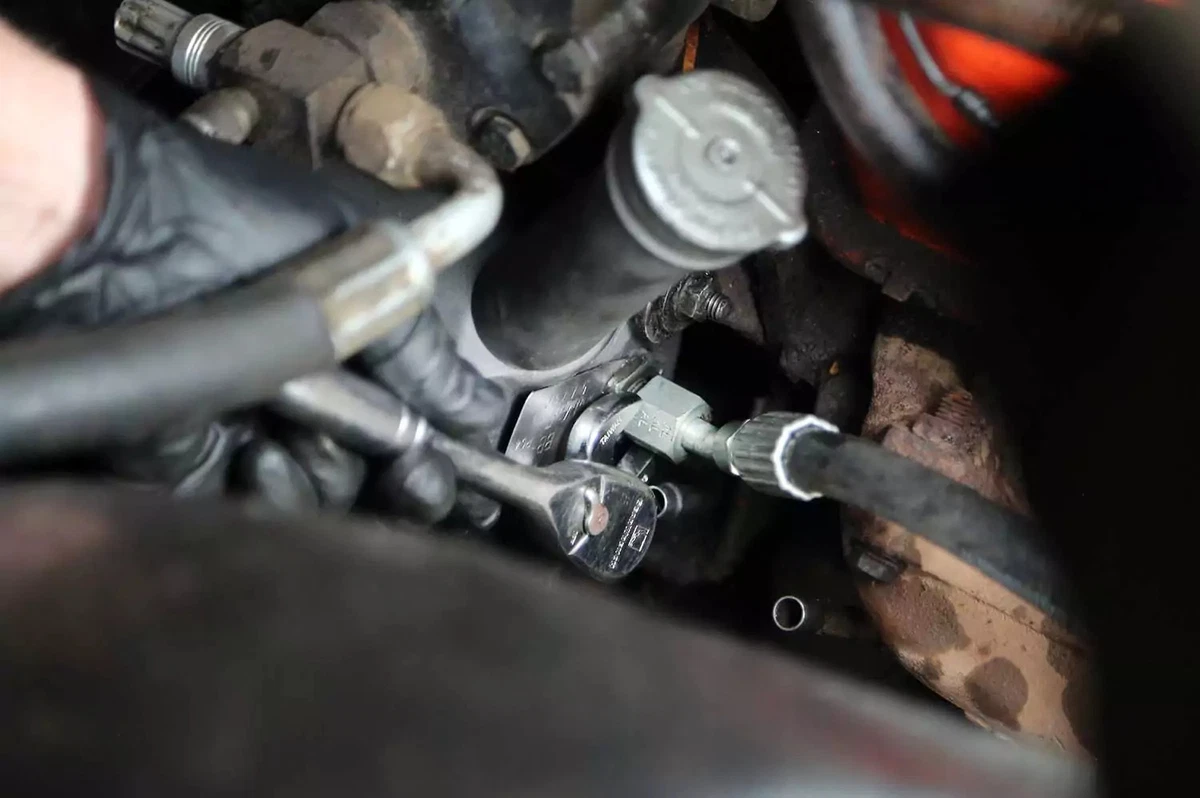 New power steering lines connected to the power steering pump.