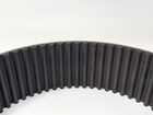 Black GATES 14MGT-994-90 poly chain belt with vertical ribbed pattern, worn white on metal side.