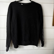 Woman's FILA black sweatshirt with FILA down the arms. SIZE L cotton/ poly blend