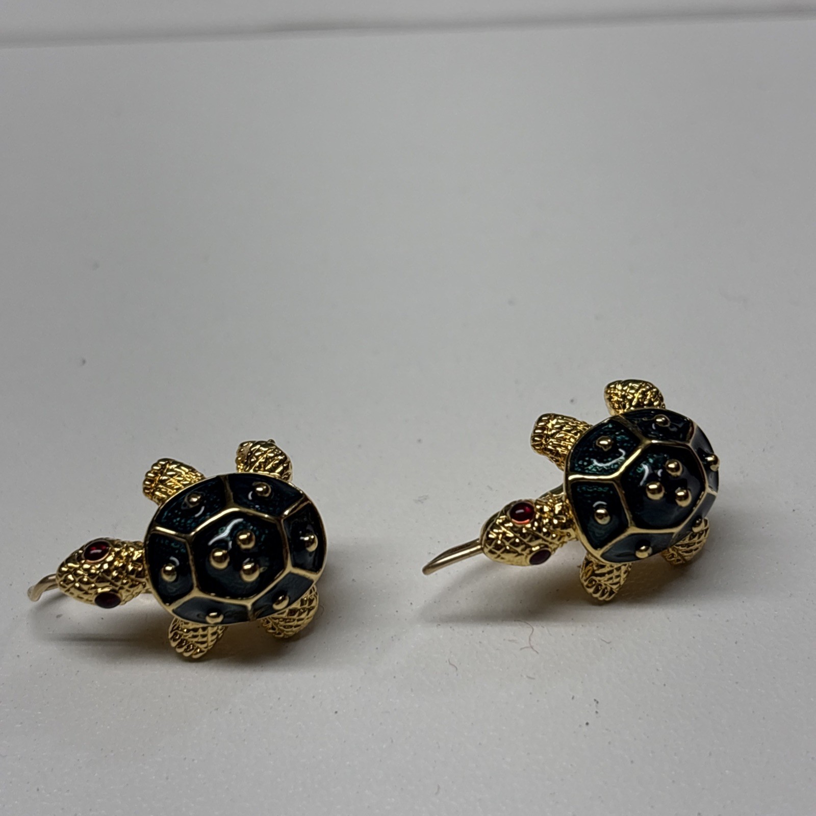 Pair of gold tone Kenneth Jay Lane earrings shaped like turtles with dark green enamel shells