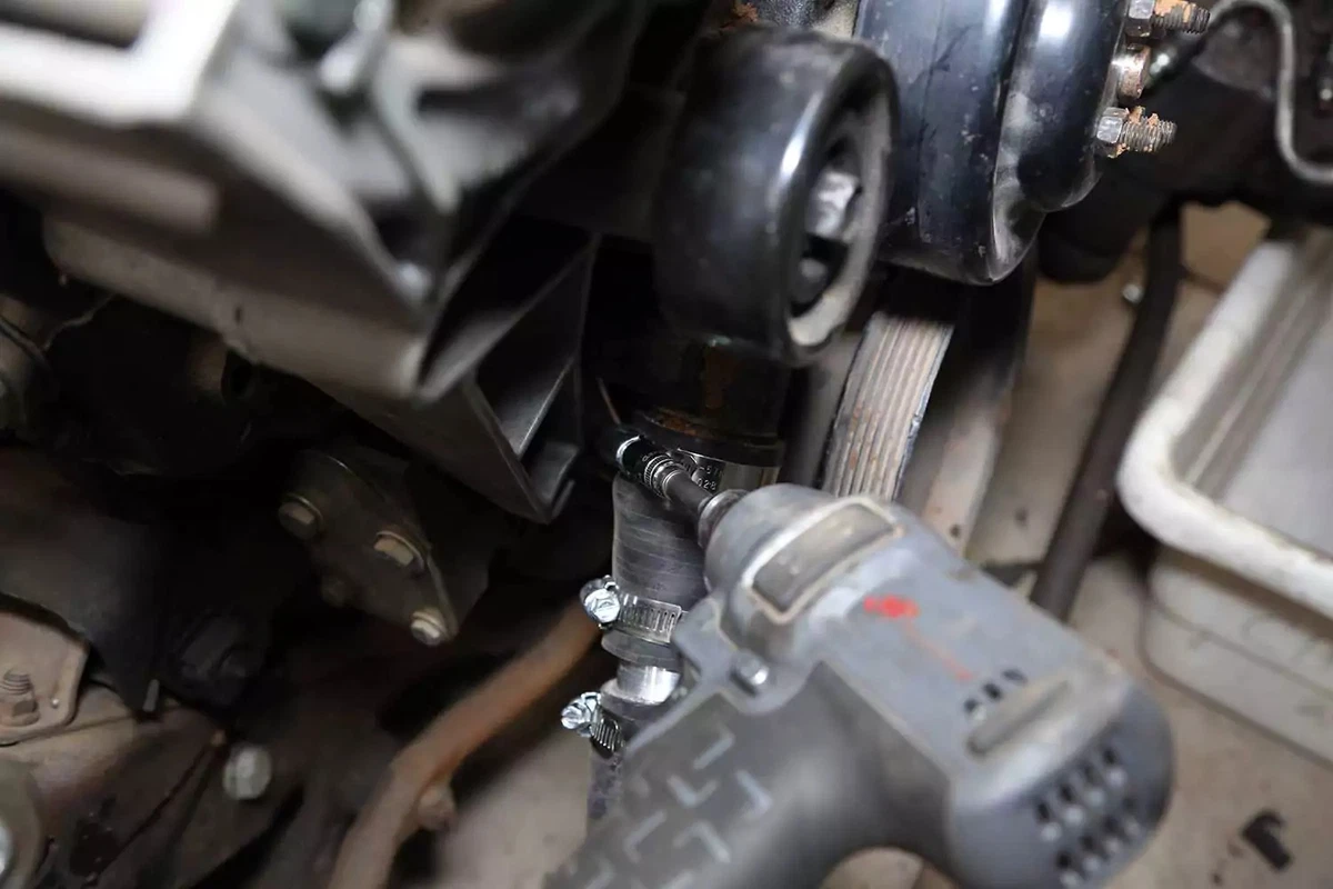 Loosening the inlet hose clamp with an impact wrench.
