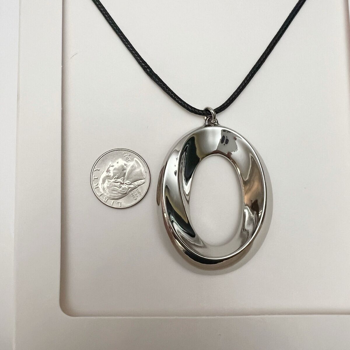 ZARA Silvertone Sculptural Circle Pendant Black Cord ZARA Silvertone Sculptural Circle Pendant Black Cord