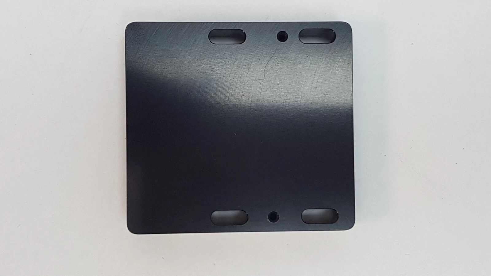 Flat back face of the Lumenis MM-004324 block with slotted holes