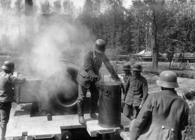 German gunner removing an empty shellcase from a howitzer Old Photo