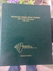 American Eagle Silver Dollar Album. With 3 BU Silver Eagles 1996, 2001, 2002