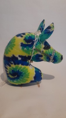 Pony head pillow made from soft plush multicolor fabric, with halter accessory