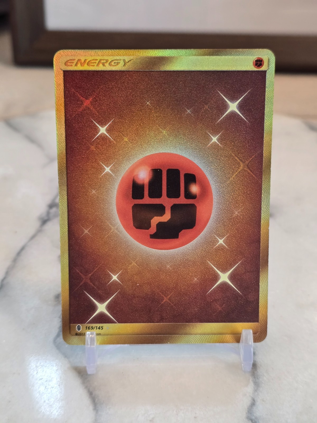 Pokemon TCG Fighting Energy (Secret) 169/145 SmGuardians Rising Holo Full Art MP