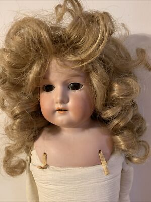 22 1/2  Armand Marseilles antique doll. Stationary eyes. Curly synthetic wig.