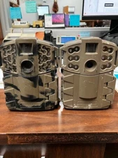 2 Moultrie Game Cameras Model MCG-12783 Camo And MCG-12688 Tan