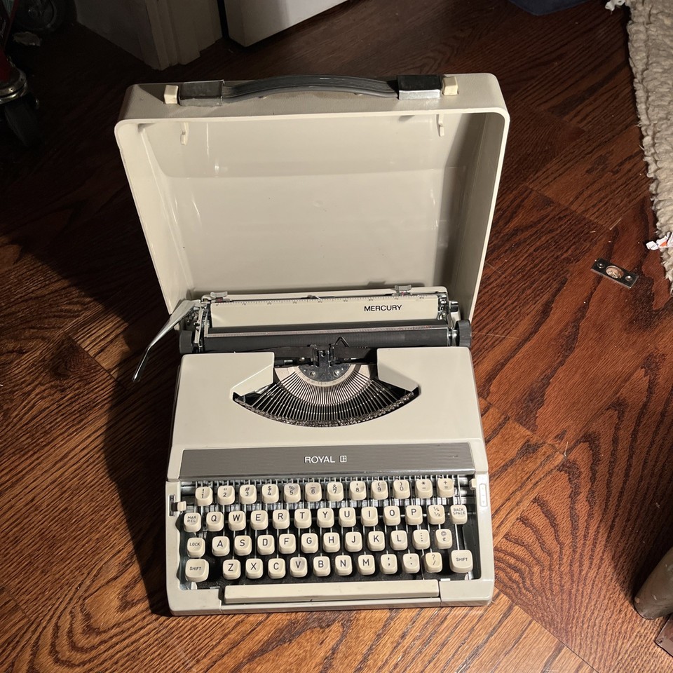 A compact vintage Royal Mercury typewriter made in Japan, complete with its original carry case — a ready-to-use retro writing machine.