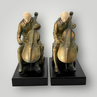 1932 PAIR OF J.B. HIRSCH J. RUHL CELLIST BOOKENDS BRONZED METAL w/ IVORINE HEADS