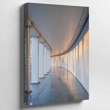 Minimalist, Modern Architectural Corridor Featuring A Series Of White Wall Art