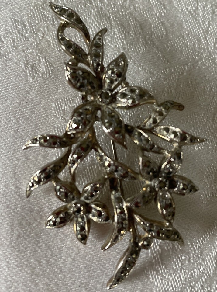 Antique sterling silver macasite brooch of spray of flowers strong