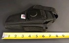 Black nylon IWB holster with black strap, double stitching, and molded pistol shape on a dark background.