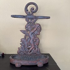 VICTORIAN CAST IRON CHERUB UMBRELLA CANE STAND.
