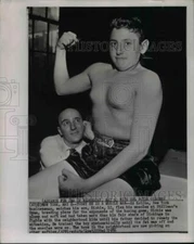 1956 Press Photo Ed Kotite watches his son Ritchie as he shows his muscles