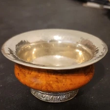Antique Tibetan burlwood tea bowl with a silver lining and base. 