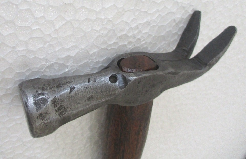 A sculptural, figural antique claw hammer that's as much folk-art object as it is tool — the kind of thing that stops guests dead in their tracks on a shelf.