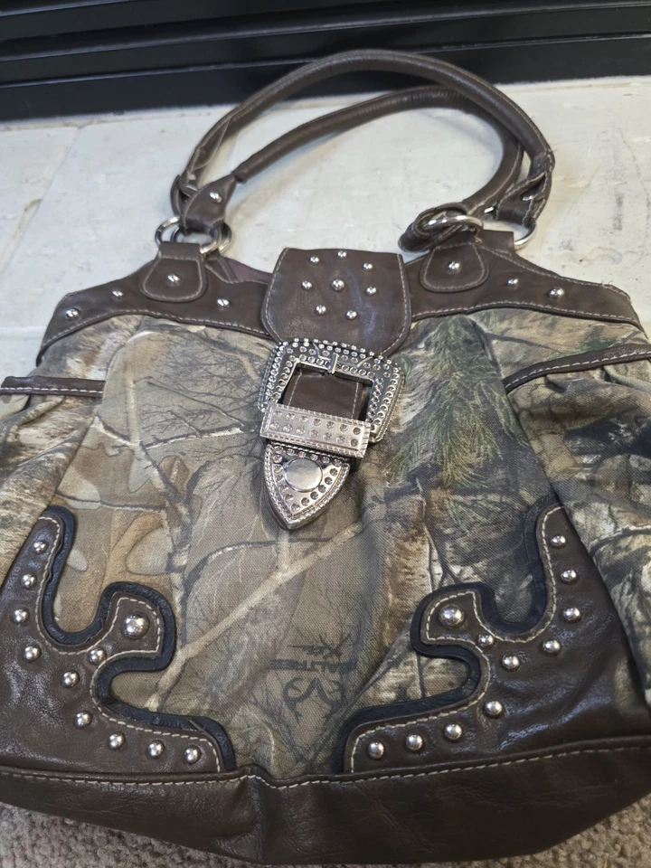 Bolso de mano Realtree camuflado con hebilla y detalles plateados Foto 2 de 4