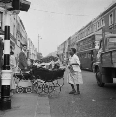 Mother pushing a pram across Portobello Road in Notting Hill, Londo - Old Photo