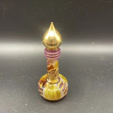 Vintage Musk Perfume Glass Bottle with purple and gold design and gold lid.