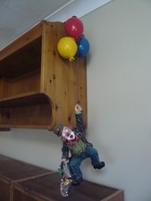 Set of three ceramic clowns, one broken coat-tail. Small crack in umbrella.