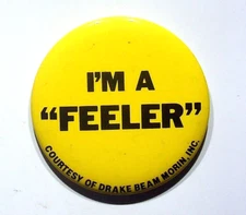 VTG. YELLOW METAL ADVERTISING PINBACK BUTTON VINTAGE DRAKE BEAM MORIN FEELER
