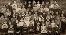 SCHOOL PHOTO, YOUNG STUDENTS POSED IN FRONT OF BUILDING. SILVER PRINT, TONED.