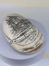 A faux scrimshaw whales tooth of Ascension island & ship with cannon