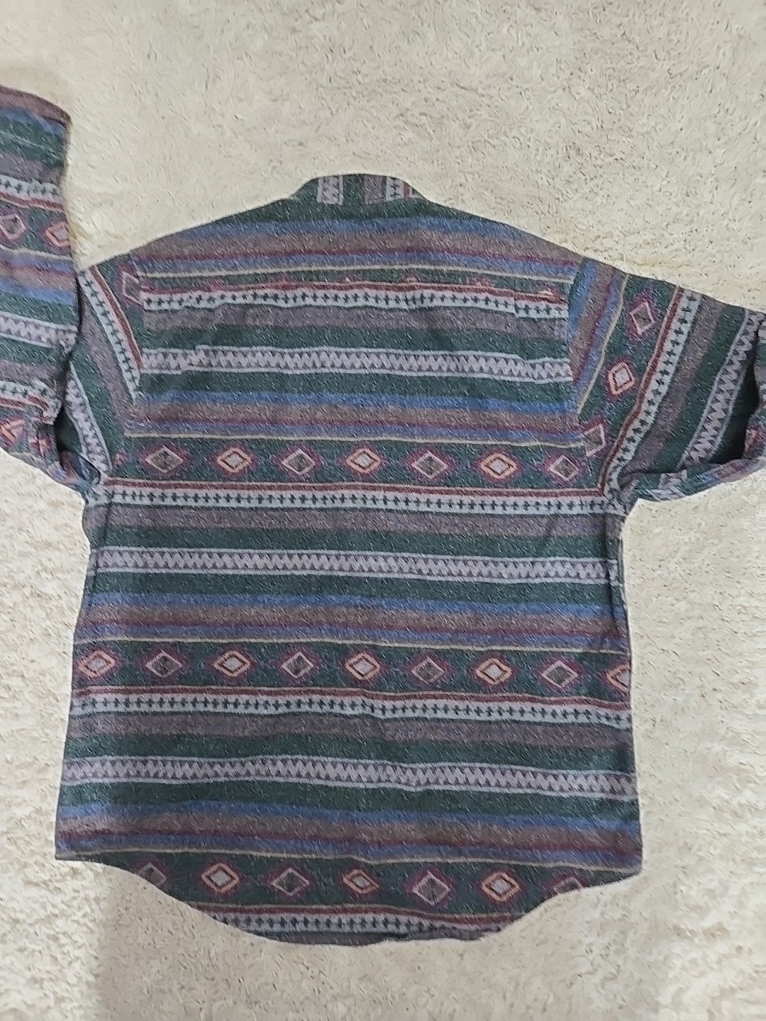 Gray LL Bean men’s flannel shirt with multicolor diamond pattern on back, short sleeves, and button-down front.