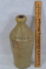 antique stoneware bottle J R Wyman 10.25 tape...