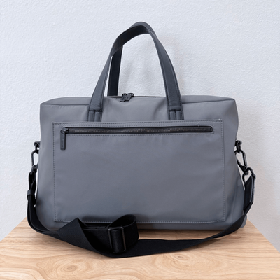 away travel duffel bag The Overnight in Coast Blue A trolley sleeve slides over any luggage handle 12 Away Luggage Sale Picks