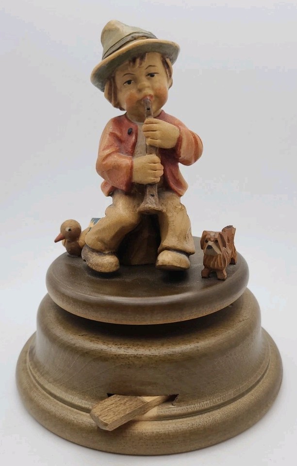 A Swiss Reuge figural music box shaped like a boy with a duck and dog — plays Edelweiss and is the kind of charming, handcrafted kitsch that has aged into genuine collectibility.