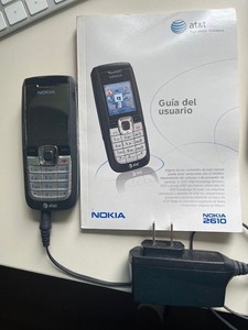 Flip phone and Nokia 2610 tiny phone plus charger and instruction book