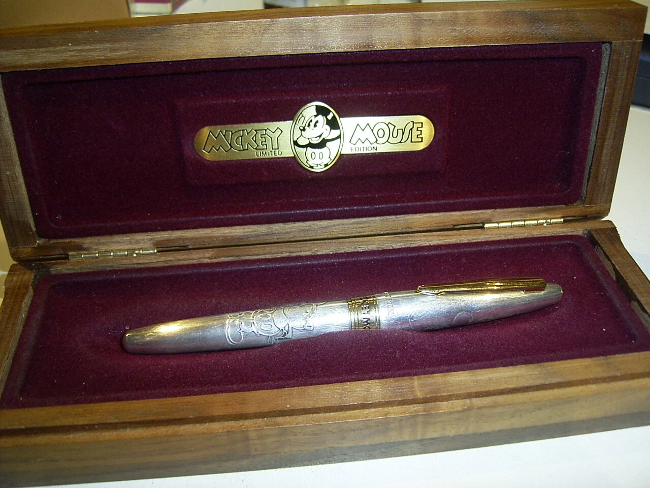 Sterling silver Pilot pen with engraved Mickey Mouse design in brown velvet box with gold lettering on lid.