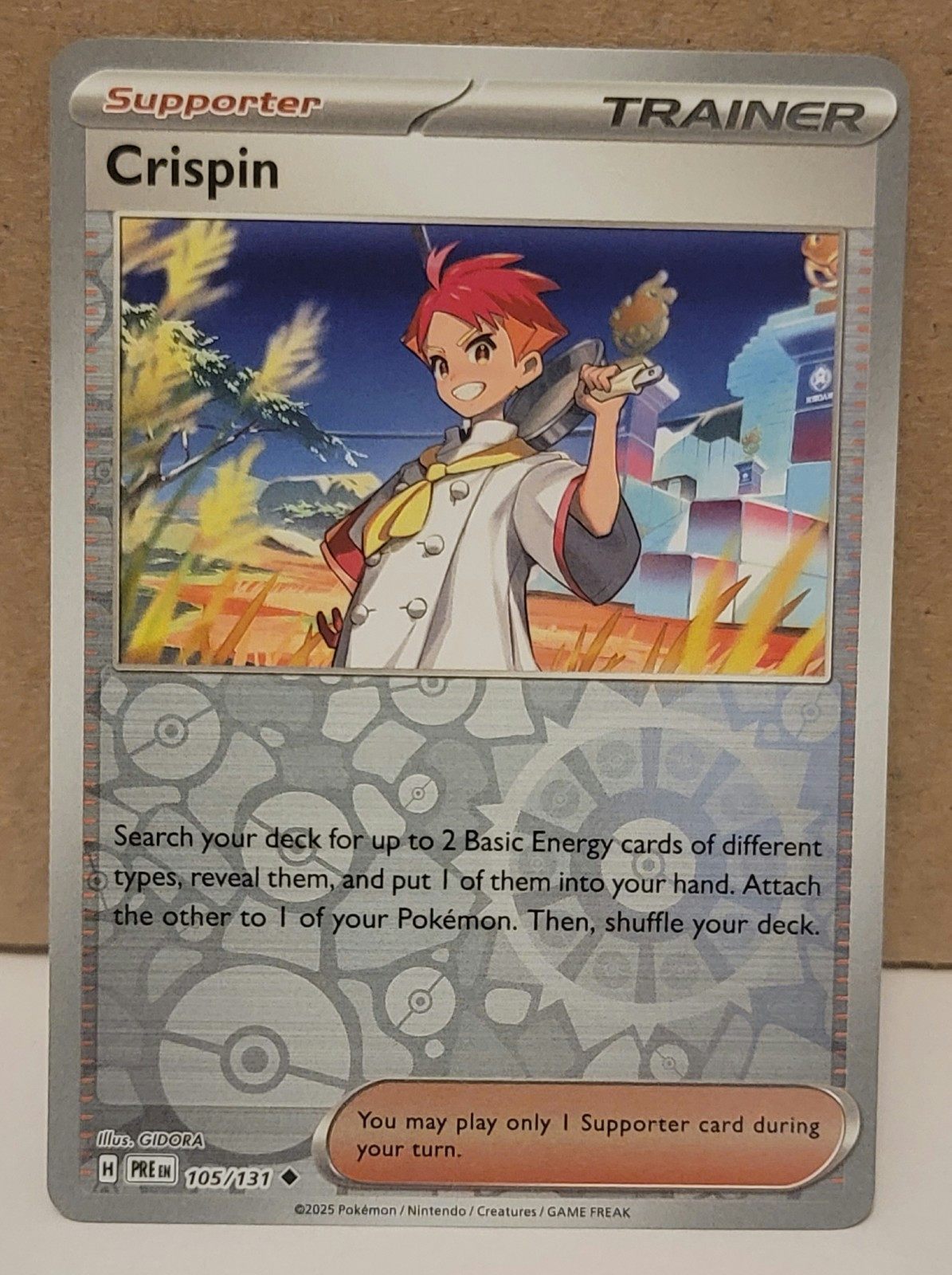 Pokemon TCG Card - 105/131 Crispin - Prismatic Evolutions - Reverse Holo NM