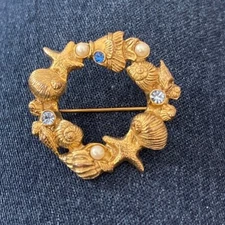 Gold Seashell Brooch with Blue and White Accents