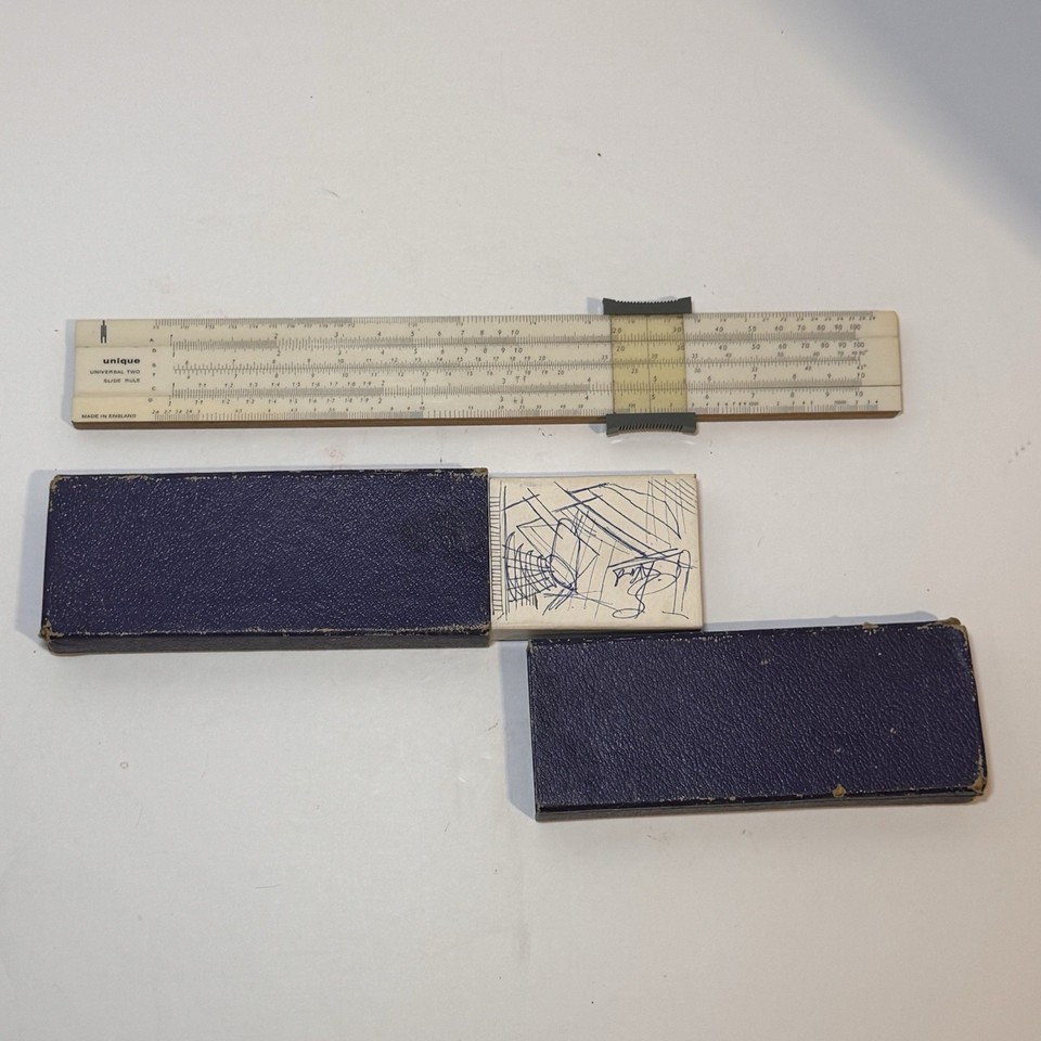 A dual-sided British slide rule in its original case — a compact piece of engineering history that doubled as a ruler and still has all its scales intact.