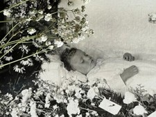Large post mortem cabinet card of child with floral tributes