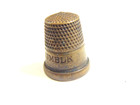 older brass colored thimble captioned "Her Majesty's Thimble England" — photo 5