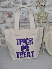 Trick or treat bag in natural with purple writing