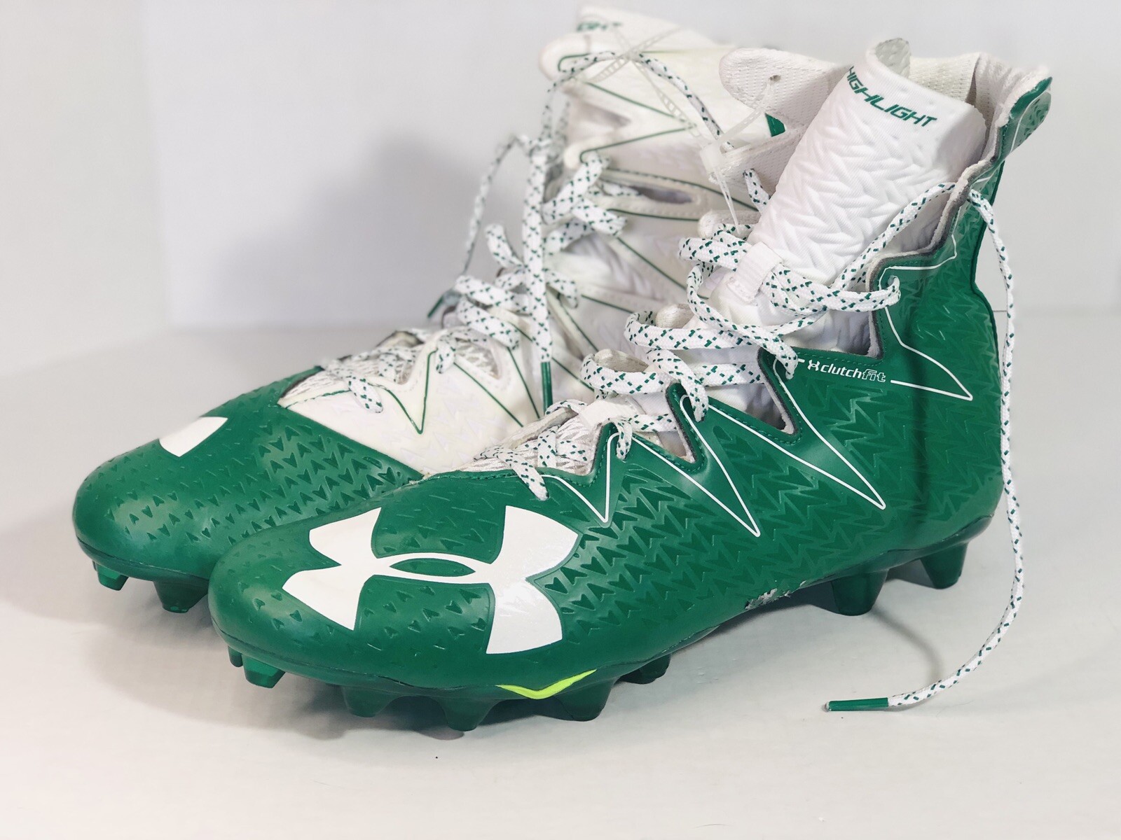 green and white under armour football cleats