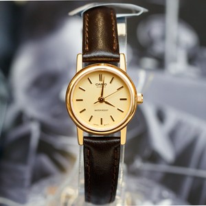gold face watch with leather band