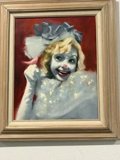 painting blonde female clown with a bright red nose and exaggerated red lipstick