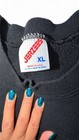 Black crewneck sweatshirt XL with white “JERZEES MADE IN U.S.A.” label and blue marbled nail polish.