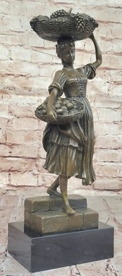 Contemporary bronze sculpture of girl with fruit basket Lost wax Method statue