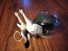 2 flying swans over glass ball ornament