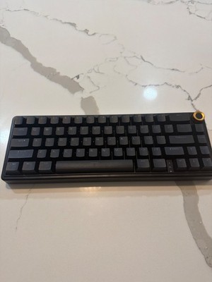 Black creamy color changing gaming keyboard with padding on the bottom 