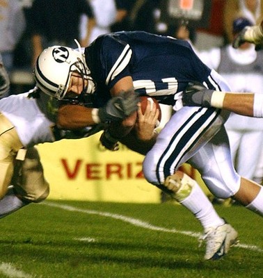 Quarterback John Beck is hit hard by a CSU defender during the sec- Old Photo